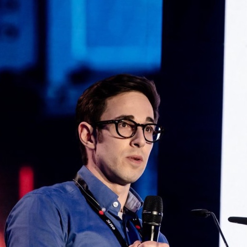 Portrait of Dr Joshua Rasera speaking at a conference